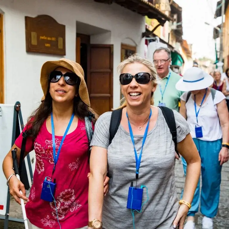 Tourists walking in a vibrant street.