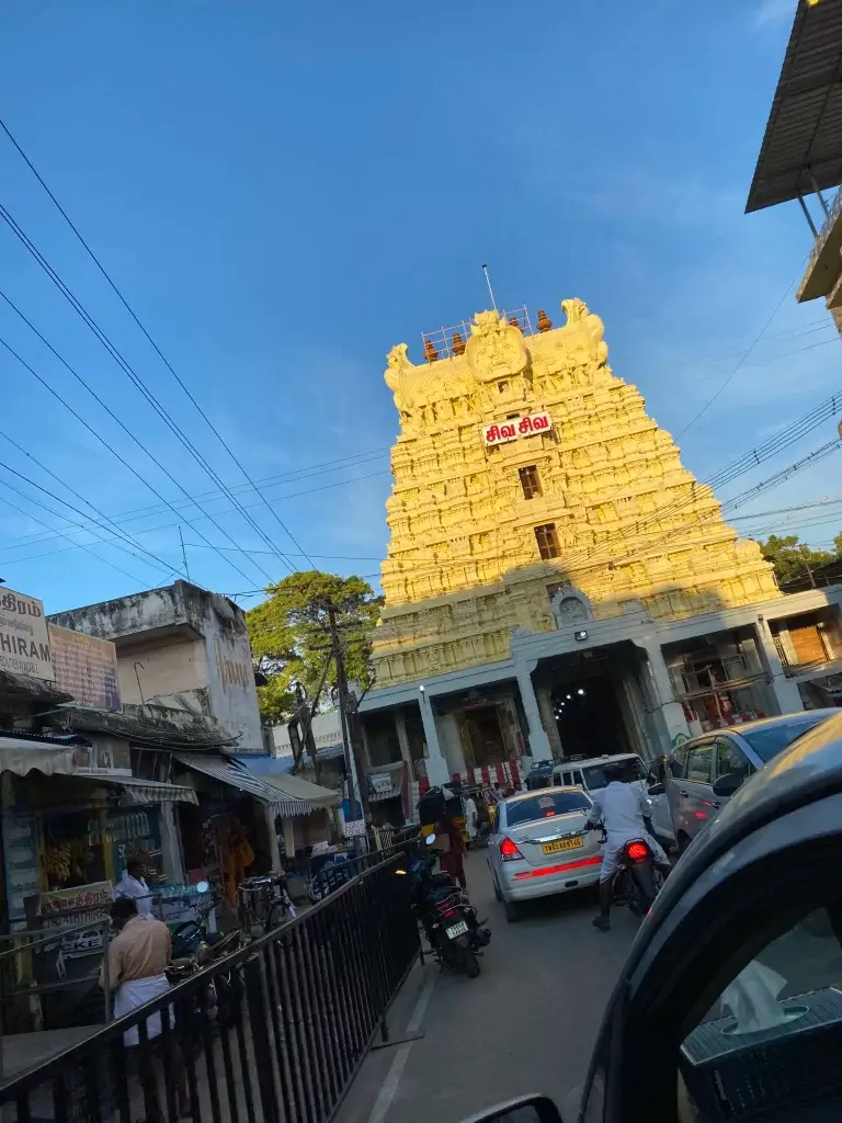 Golden temple structure with intricate carvings and a clear blue sky in Rameshwaram.