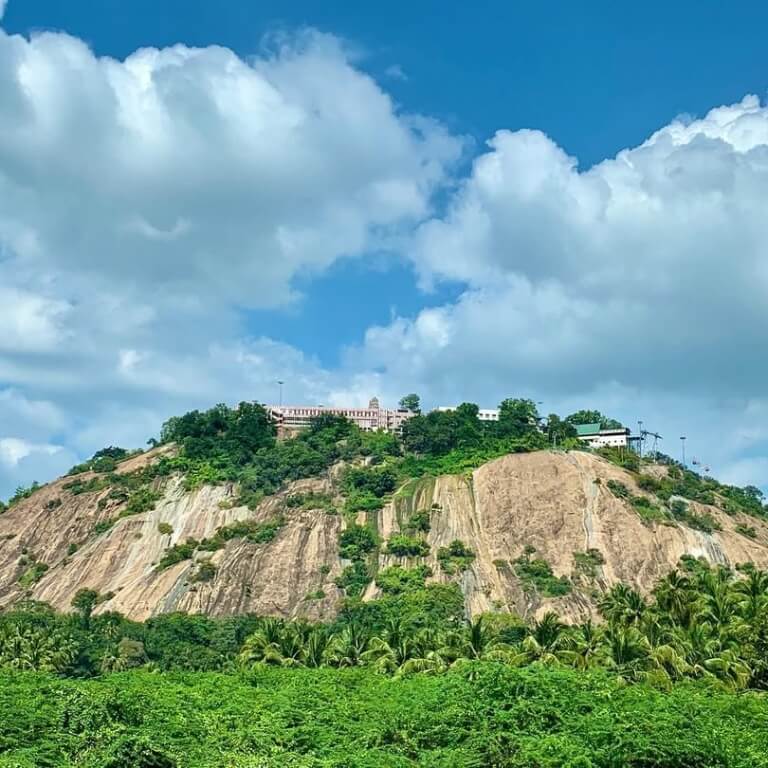 Hilltop structure surrounded by greenery